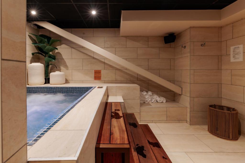 a swimming pool in a room with a stairs at Keystone Hôtel & Spa in Lyon