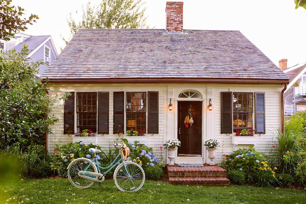 a blue bike parked in front of a house at The Groggy Anchor in Provincetown