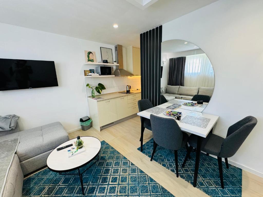 a living room with a couch and a table in a room at Golden Soul Sarajevo Old town - Walk everywhere in Sarajevo