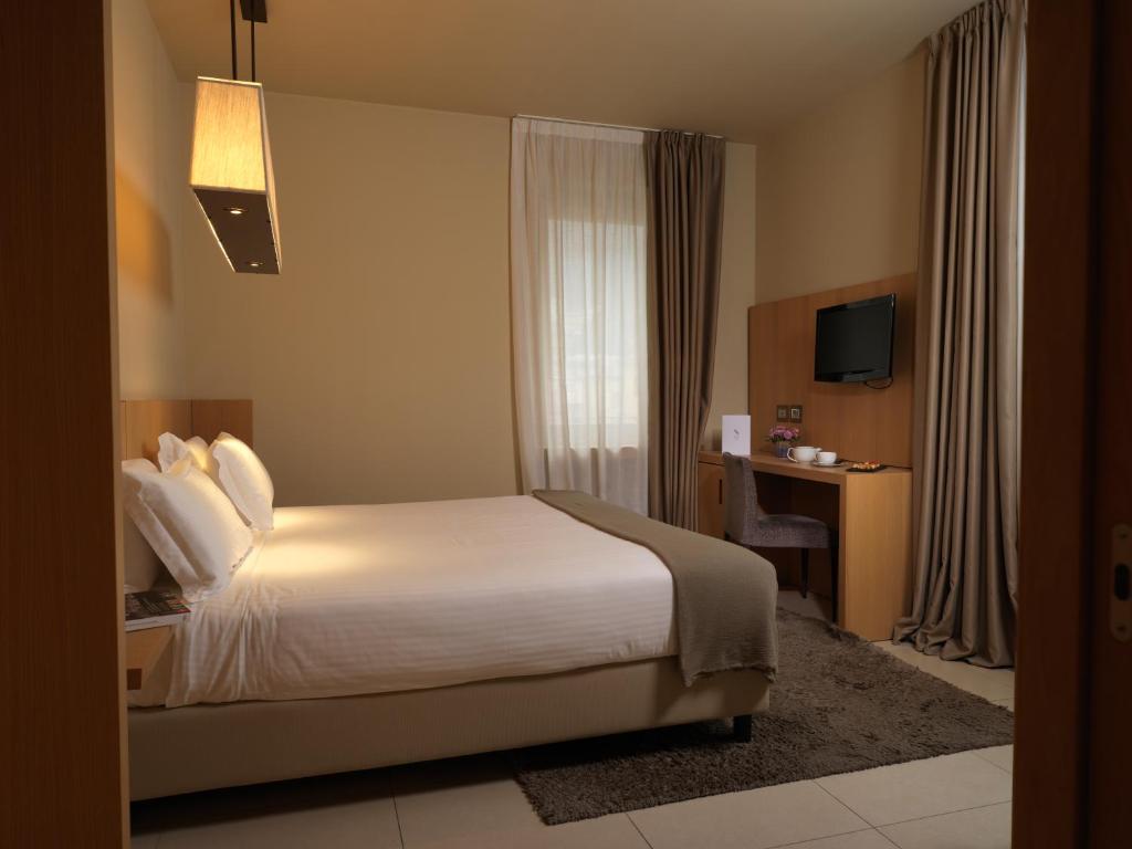 Postel nebo postele na pokoji v ubytování Albergo Nicolin