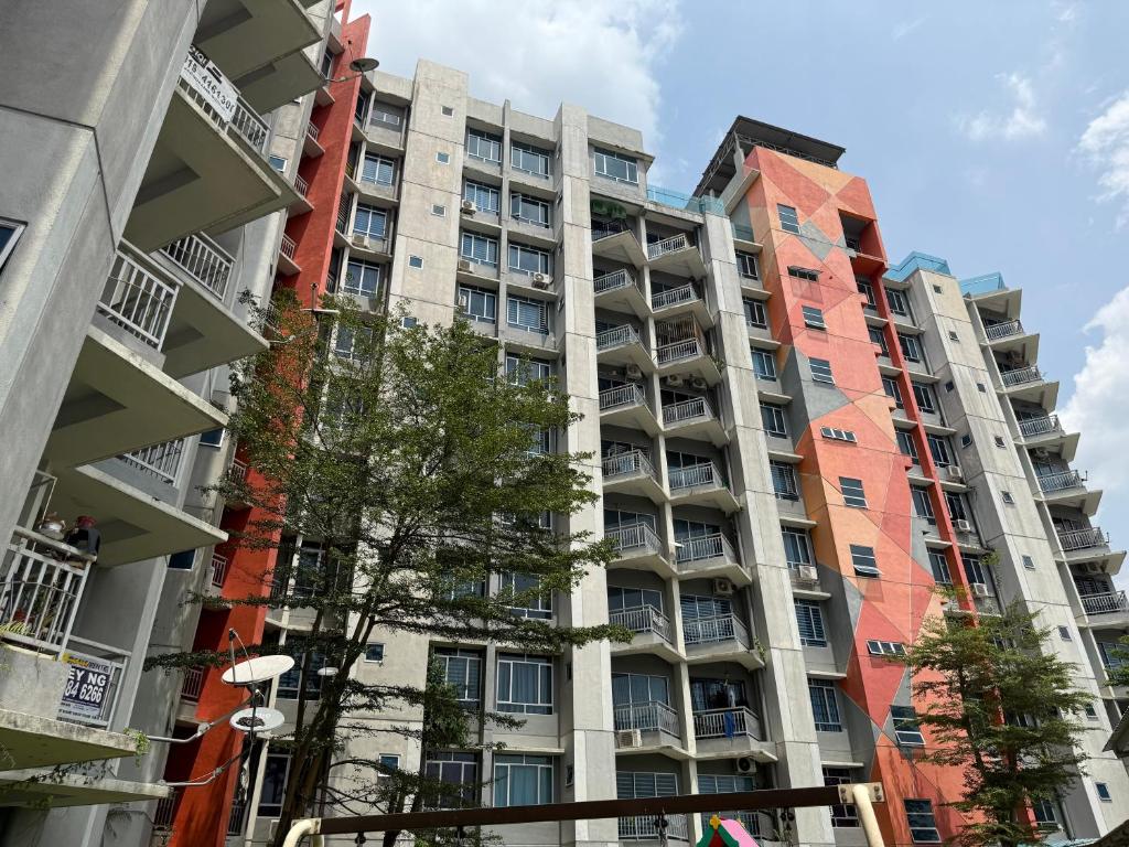 a tall apartment building in a city at Bright Apartment in Klebang in Ipoh