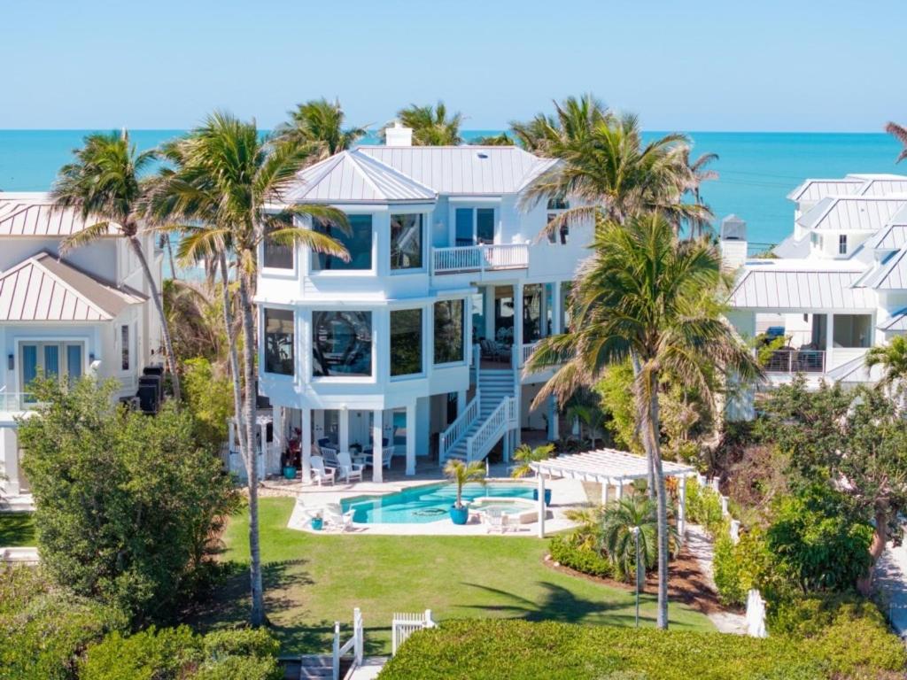 an aerial view of a large white house with palm trees at Captiva Grace home in Captiva