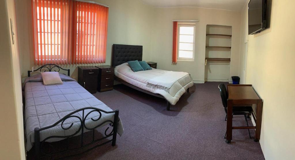 Ένα ή περισσότερα κρεβάτια σε δωμάτιο στο Habitaciones privadas en Centro de La Paz