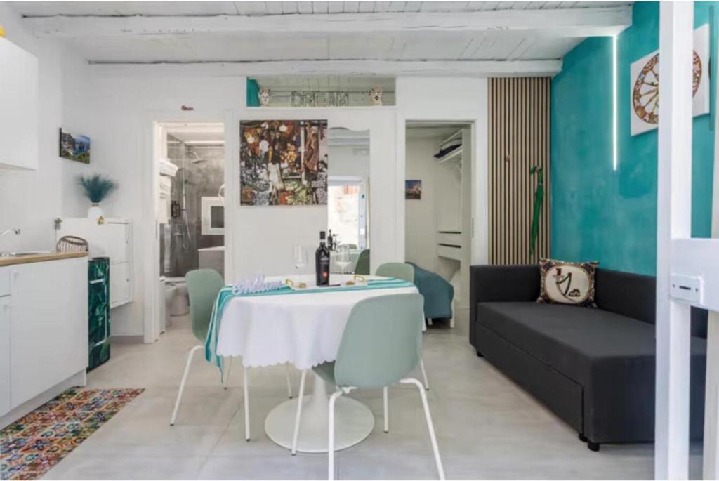 a living room with a table and a couch at Apartment al Vicolo 27 in Palermo