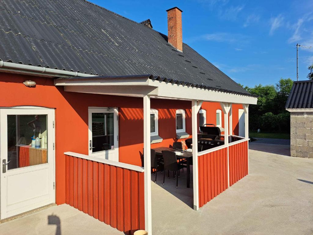 an orange house with a table in it at Idyllic Country Apartment Incl All Utilities in Christiansfeld