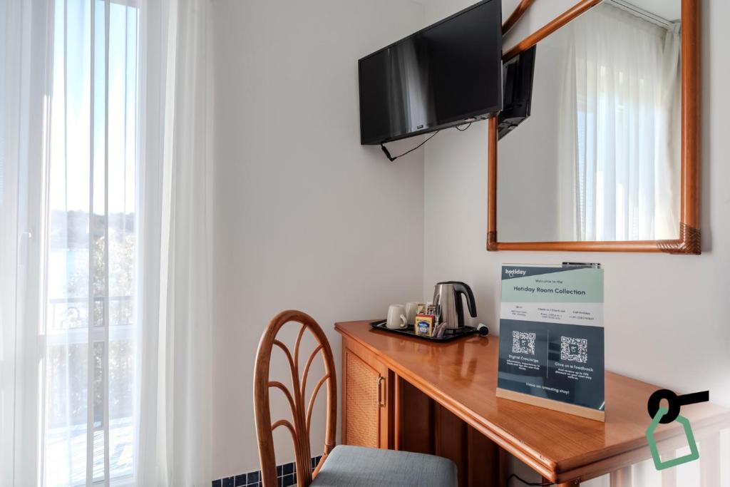 TV a/nebo společenská místnost v ubytování HOTIDAY Room Collection - Le Grazie