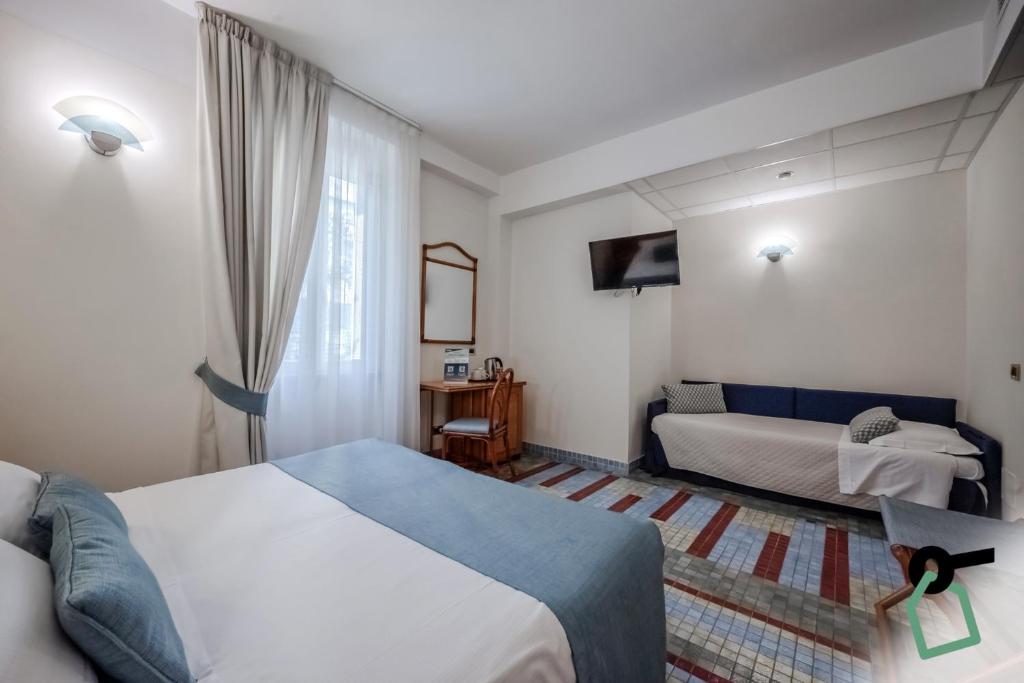 Postel nebo postele na pokoji v ubytování HOTIDAY Room Collection - Le Grazie