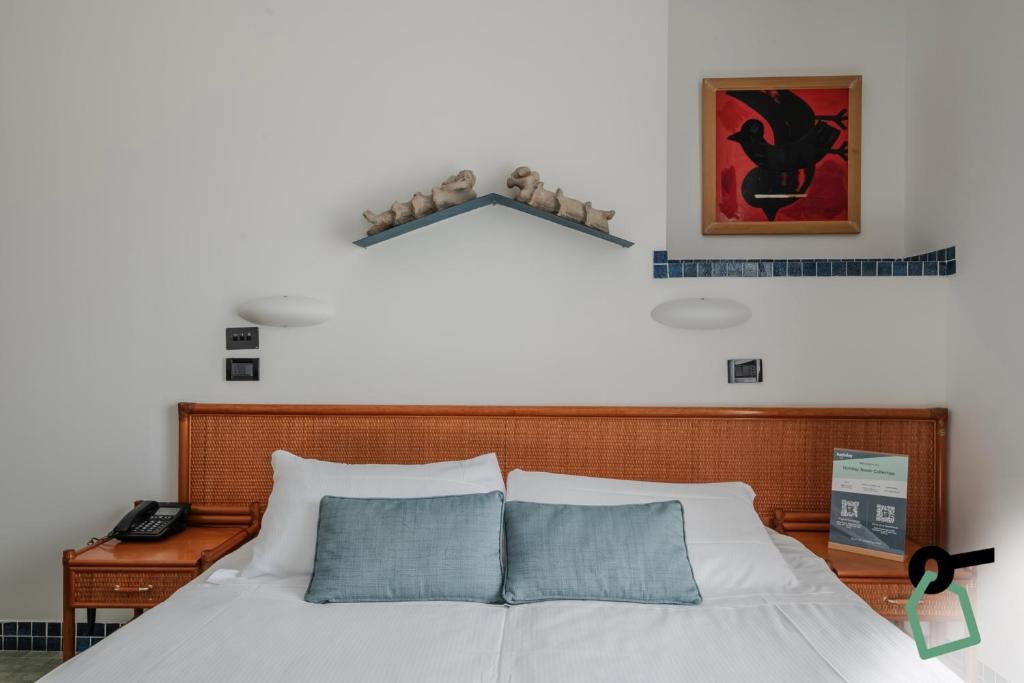 Postel nebo postele na pokoji v ubytování HOTIDAY Room Collection - Le Grazie