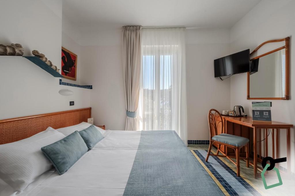 Postel nebo postele na pokoji v ubytování HOTIDAY Room Collection - Le Grazie