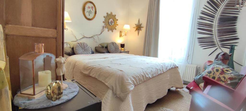 a bedroom with a bed and a mirror at PARIS AUTHENTIC HOUSE Métro 14 Station Hôpital Bicêtre, RER B Gentilly in Paris