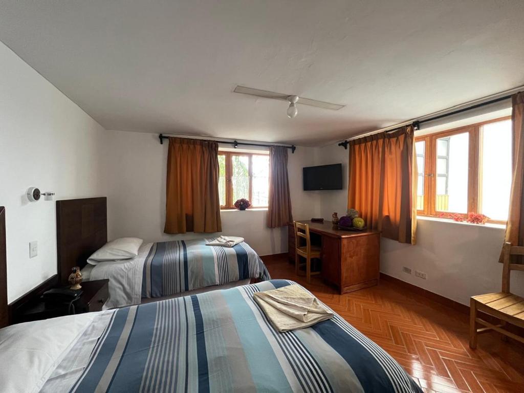Postel nebo postele na pokoji v ubytování Yanapanakusun Cusco