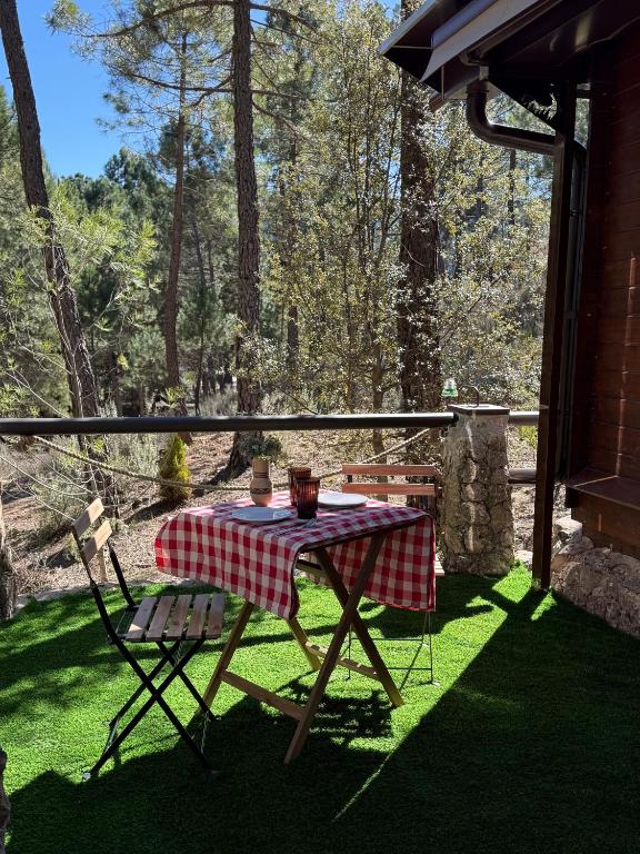 a table and chairs on a porch with a picnic table at Casa Rural Mi Camino in Riópar