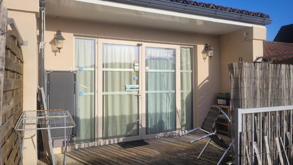 a large glass door on a balcony of a house at Hotel La Peyrade in Cajarc