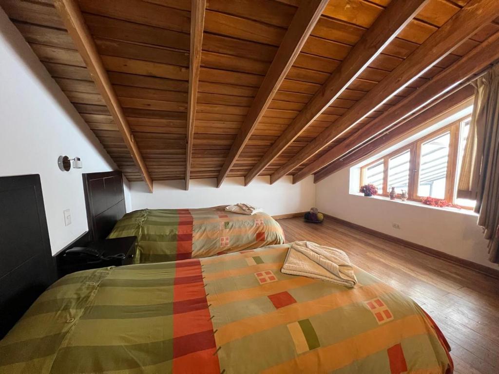 Postel nebo postele na pokoji v ubytování Yanapanakusun Cusco