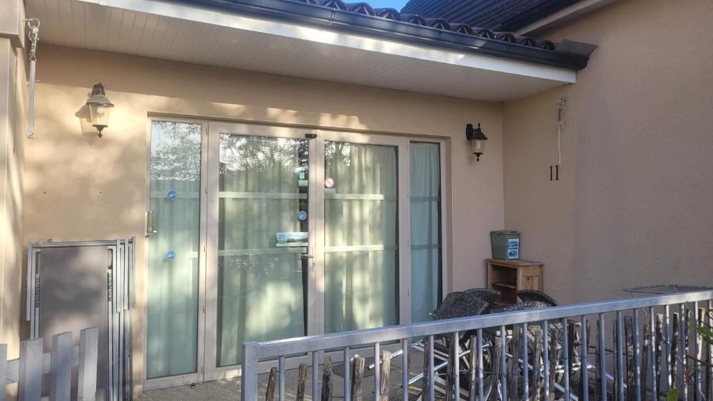 a balcony with a glass door on a house at Hotel La Peyrade in Cajarc