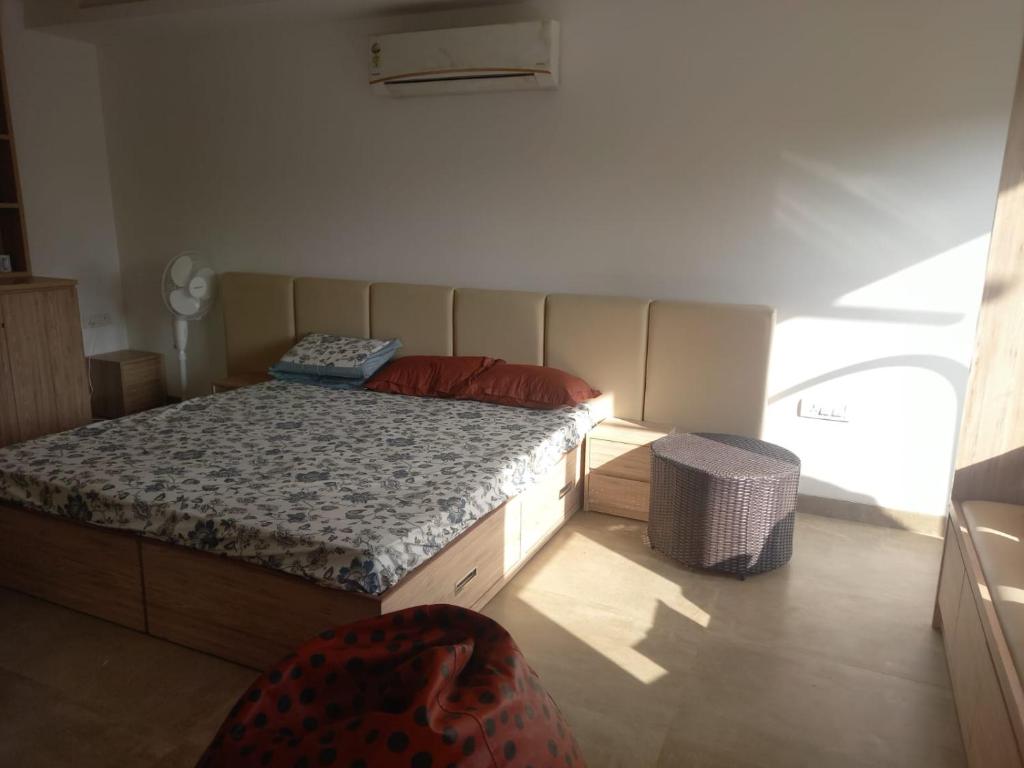 a small bedroom with a bed and a window at Savant in Gurgaon