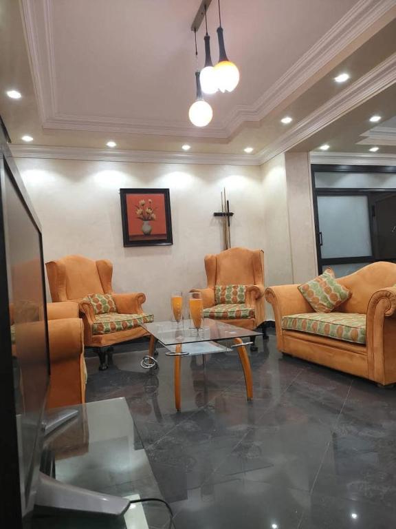 a living room with couches and a coffee table at فيلا مفروشه بالكامل in Madinaty