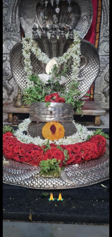 a altar with red and white flowers on a chair at Mamatha Guest inn in Hampi