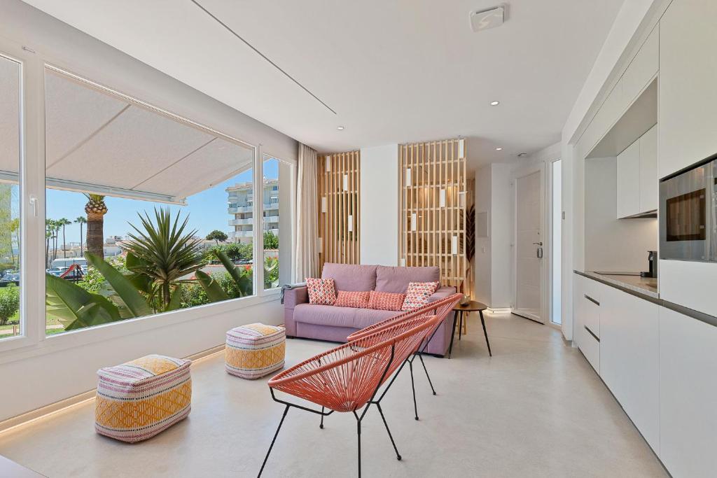 a living room with a couch and a table at ALGAIDAMAR BEACH LUXURy in Sitio de Calahonda