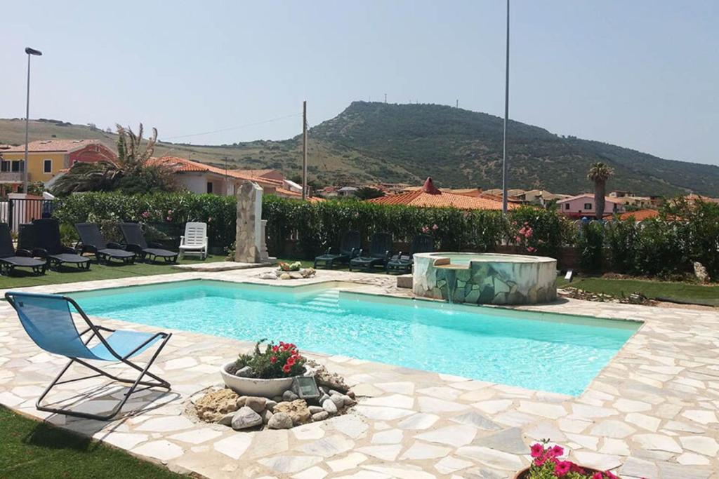 a swimming pool with a chair in a yard at Residenza Agnese Sardegna in La Ciaccia