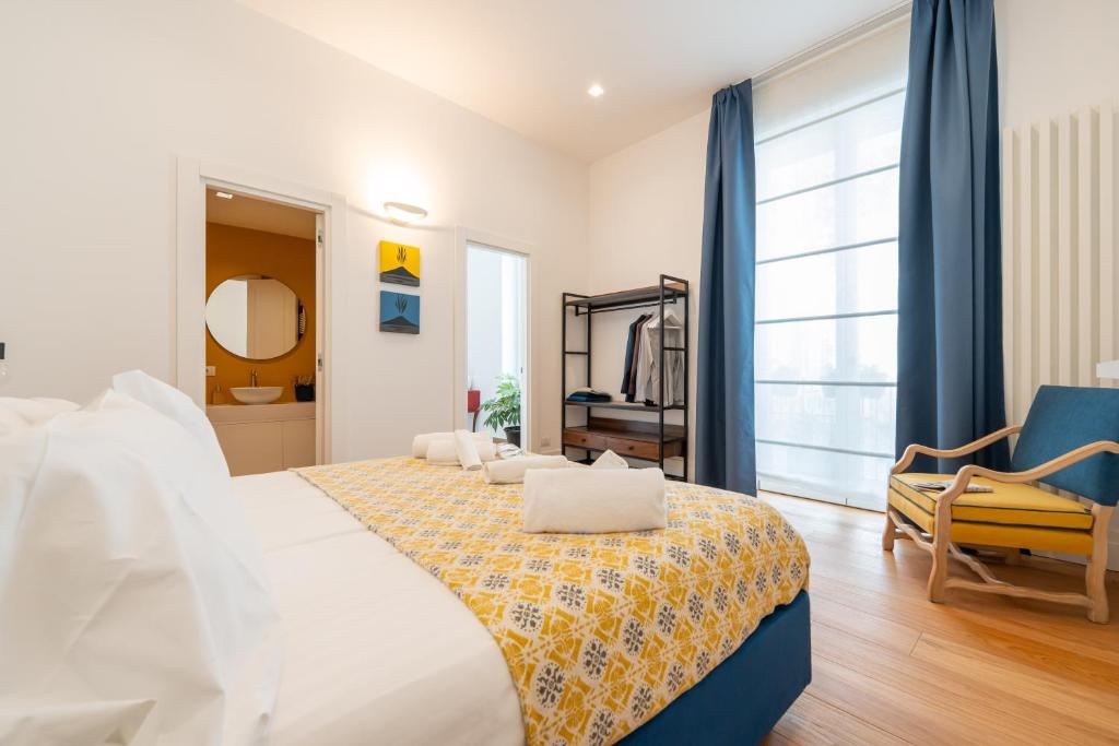 a bedroom with a large bed and a chair at La SuiteDellAvvocato in Naples