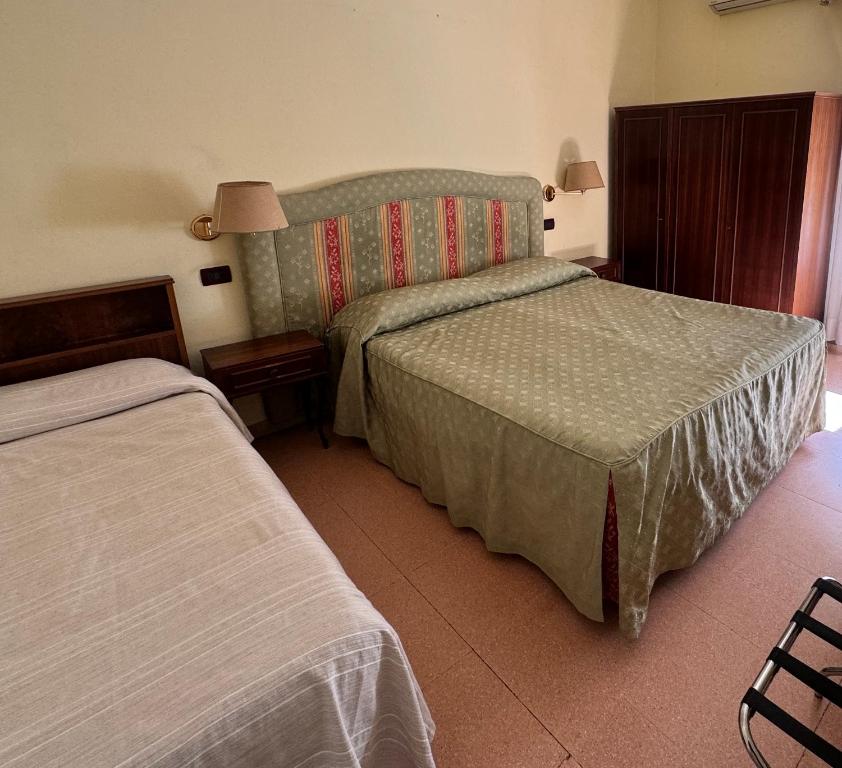 Postel nebo postele na pokoji v ubytování Hotel Ely