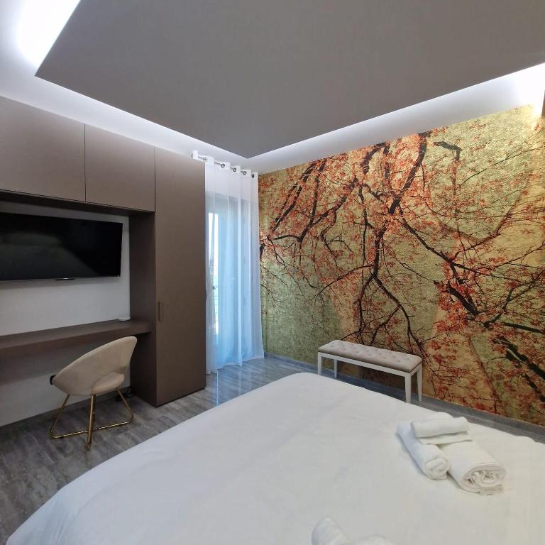una camera con letto, TV e murale di House 21 Residence Room a Collecchio