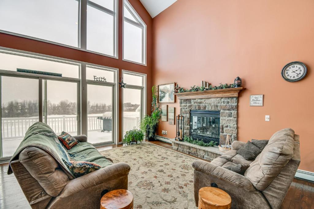 a living room with two couches and a fireplace at The Gathering Place Rushville Home with Hot Tub in Rushville