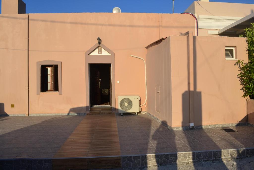 a door to a building with a fan next to it at michaelas traditional house in Fánai