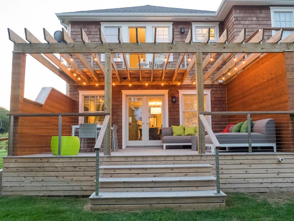 a porch with a pergola on a house at North Harbor Montauk in Montauk