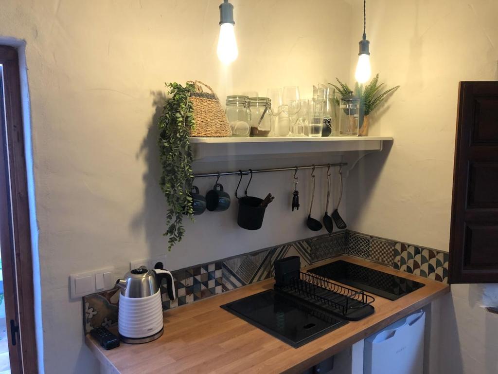 a kitchen with a counter with a stove top oven at Casita with Views of Frigiliana in Frigiliana