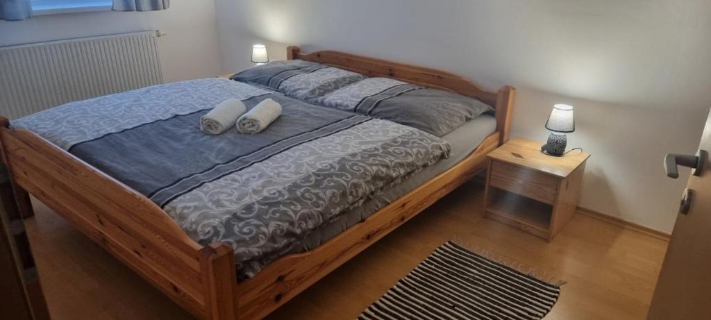 a bedroom with a wooden bed with two pillows on it at Ubytovanie v centre s garážovým státím in Piešťany
