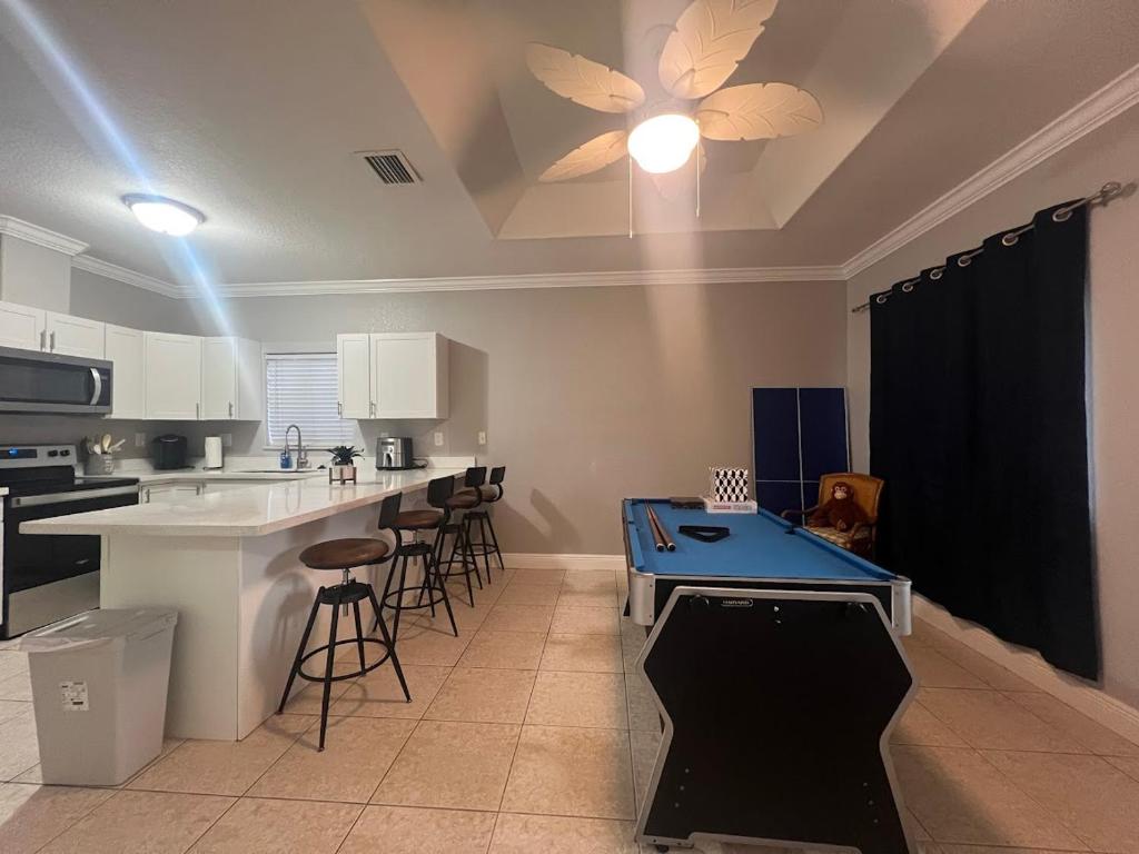 a kitchen with a blue ping pong table in it at Homestead Green retreat in Homestead