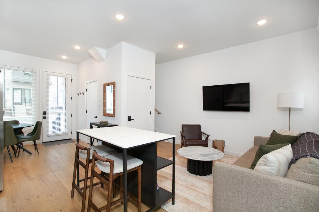 a living room with a couch and a table at Modern Cityscape Downtown Knoxville in Knoxville