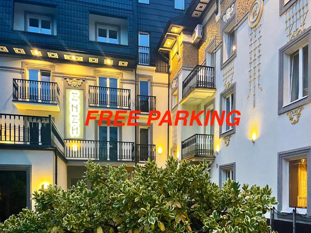 a sign that says free parking on the side of a building at Penthouse Apartment in Hotel Eney in Lviv