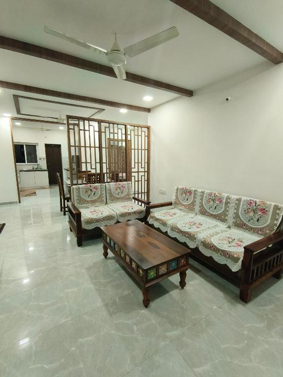 a living room with two couches and a coffee table at Ultra-Modern Fullt Furnished 2BHK Near JNTU Metro - Launched Just Now in Hyderabad