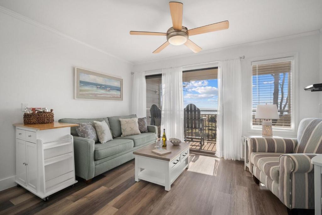 a living room with a couch and a ceiling fan at Ocean Front Condo with Private Water Front Balcony in Hilton Head Island