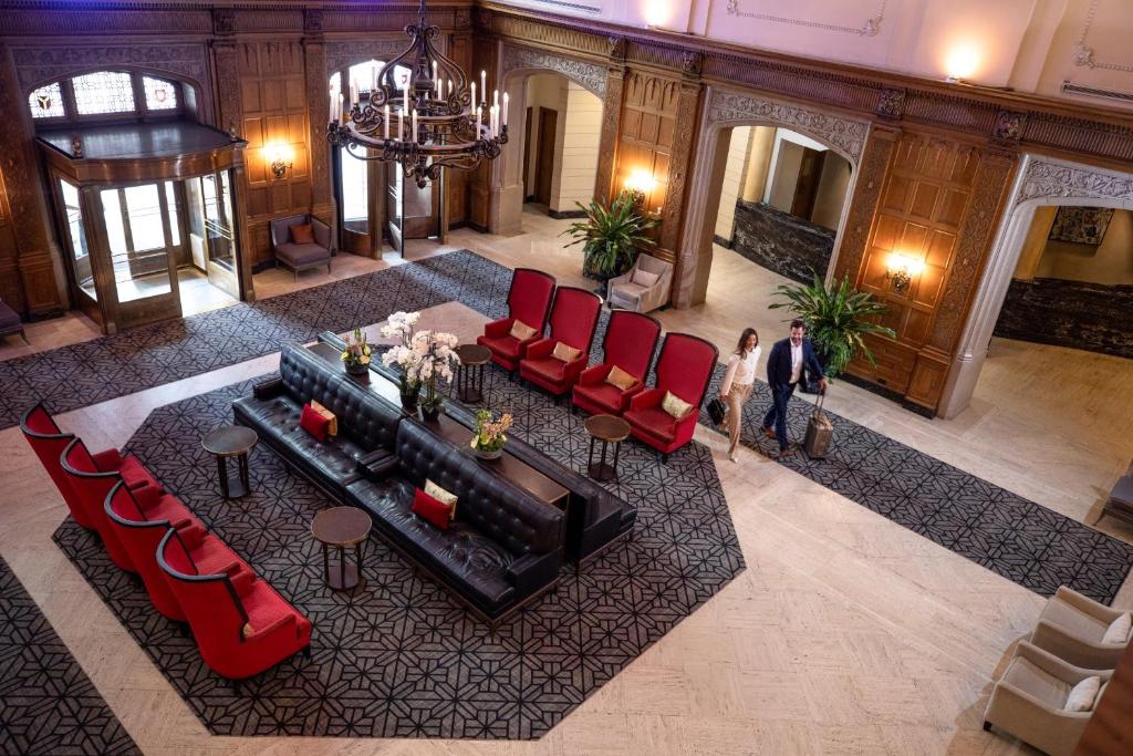 an overhead view of a lobby with red chairs and a table at Fairmont Chateau Laurier in Ottawa