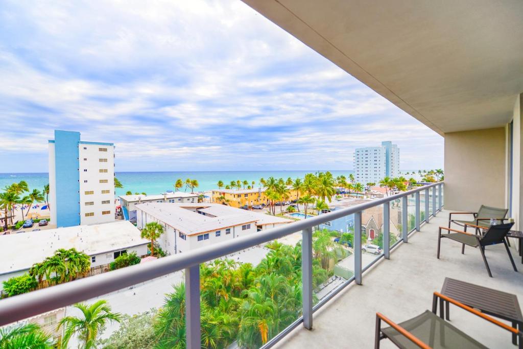 a balcony with a view of the beach and buildings at Direct Ocean view Condo Steps from the Beach in Hollywood
