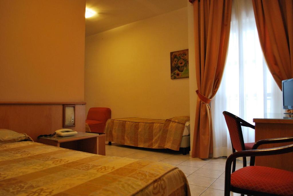 Postel nebo postele na pokoji v ubytování Hotel Tre Torri