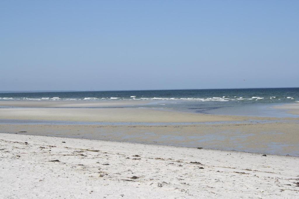 an empty beach with the ocean in the background at Dennis Village Adorable Studio Cottage 5951 in Dennis