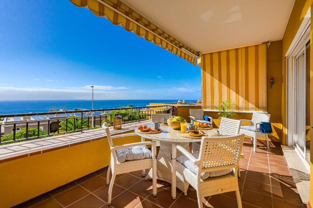 a balcony with a table and chairs and the ocean at Hermitage Homes RPLA in Puerto de Santiago