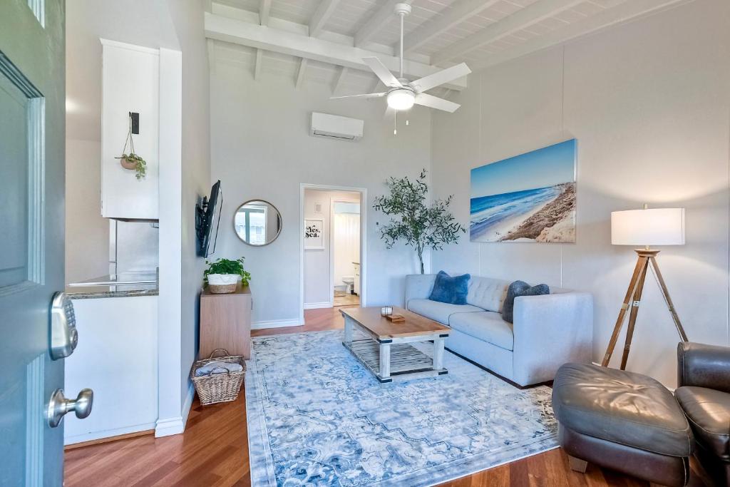 a living room with a blue couch and a table at 3080 Lincoln - Unit 12 in Carlsbad