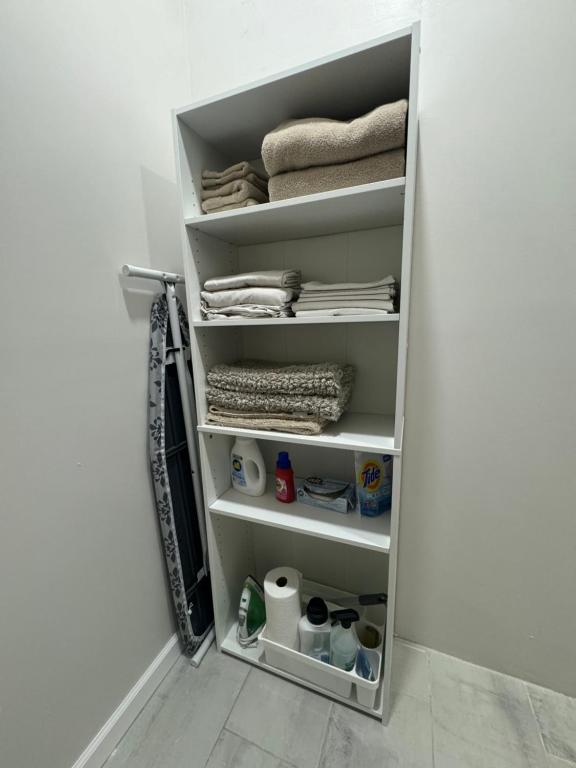 a closet with white shelves and towels and towels at Richland Villa in Vidalia