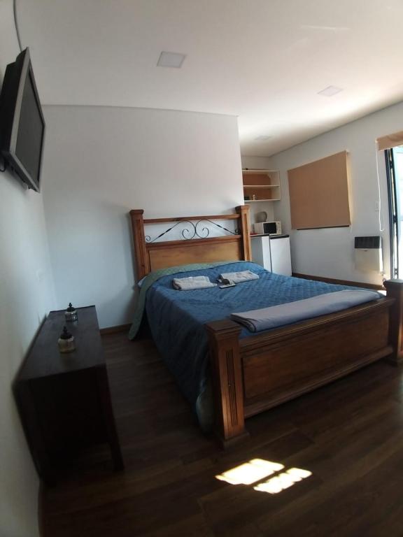 a bedroom with a bed and a table in it at El Estudio in Villa Marini