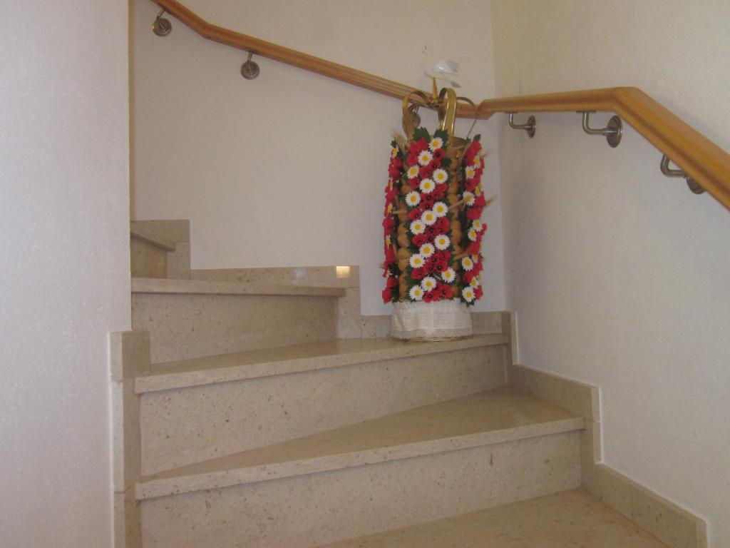 a stairway with a bag hanging on a rail at Casinha da Pedra in Tomar