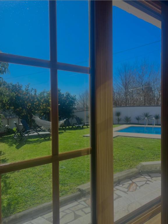 a window view of a yard and a pool at Casa do Xisto in Ponte de Lima