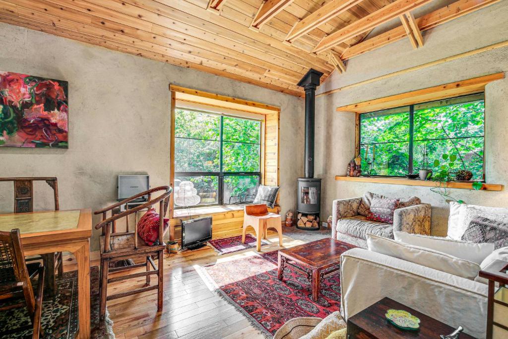 a living room with a couch and a table at Unique and Serene Retreat, 7 Mi to Downtown Portland in Portland