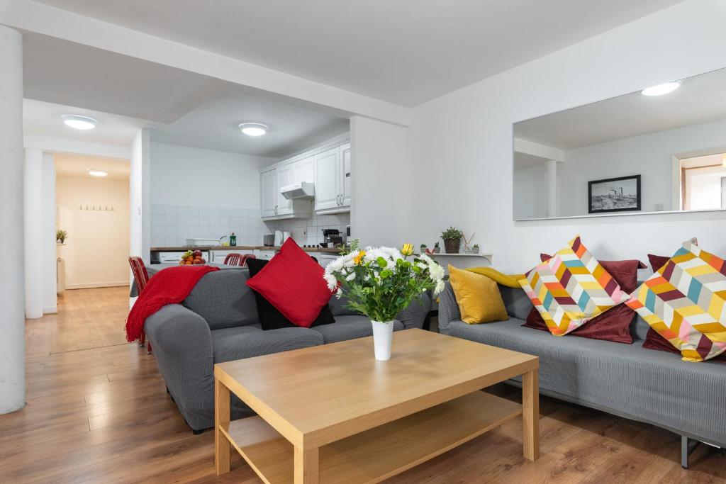 a living room with a gray couch with colorful pillows at Spacious 3-Bed Apt in Dublin Center in Dublin