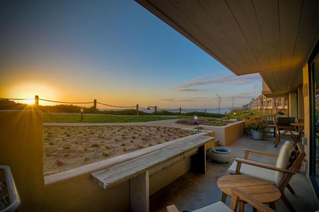 a bench on a balcony with the sunset in the background at 597 S Sierra Avenue - Unit 68 in Solana Beach